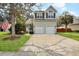 Charming home featuring a two-car garage, an American flag, and well-manicured landscaping at 3545 Rookwood Pl, Johns Island, SC 29455