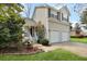 Charming home featuring a two-car garage, and a cozy front porch with manicured landscaping at 3545 Rookwood Pl, Johns Island, SC 29455