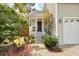 Inviting front yard with bench seating on porch, lush greenery and an elegant front entrance at 3545 Rookwood Pl, Johns Island, SC 29455