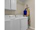 Functional laundry room with washer, dryer, and overhead storage at 3545 Rookwood Pl, Johns Island, SC 29455