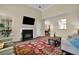 Living room with fireplace, large windows, and a view into the dining area at 3545 Rookwood Pl, Johns Island, SC 29455