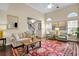 Bright living room featuring high ceilings, large windows, and stylish decor at 3545 Rookwood Pl, Johns Island, SC 29455