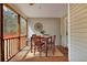 Cozy screened patio with wooden table and chairs, perfect for outdoor dining and relaxation at 3545 Rookwood Pl, Johns Island, SC 29455