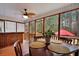 Screened patio with wooden table and chairs, a ceiling fan, and views of the backyard at 3545 Rookwood Pl, Johns Island, SC 29455