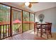 Inviting screened patio features a wooden table and chairs, with views of the backyard at 3545 Rookwood Pl, Johns Island, SC 29455