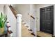 Inviting entryway featuring a staircase with carpeted steps and a black front door at 3545 Rookwood Pl, Johns Island, SC 29455