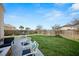 Well-maintained backyard showcasing patio, lush lawn, and fenced perimeter for outdoor enjoyment at 362 Sanctuary Park Dr, Summerville, SC 29486