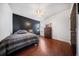 Cozy bedroom with hardwood floors, accent wall, and a comfortable queen size bed at 362 Sanctuary Park Dr, Summerville, SC 29486