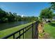 Picturesque backyard featuring a scenic lake view, lush greenery, and a secure fence at 3664 Maidstone Dr, Mount Pleasant, SC 29466