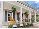 Inviting front porch featuring rocking chairs, hanging ferns, and classic design at 404 Black Oak Blvd, Summerville, SC 29485