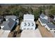 Aerial view of a modern home with a three-car garage in a lush, green landscape at 4070 Egret Perch Ct, Ravenel, SC 29470