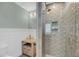 Stylish bathroom features a glass vessel sink, walk-in shower with tiled walls, and coastal-inspired decor at 4070 Egret Perch Ct, Ravenel, SC 29470