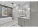 Bright bathroom featuring a soaking tub, glass shower, and gray vanity with a marble countertop and a mosaic tile floor at 4070 Egret Perch Ct, Ravenel, SC 29470