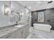Bright bathroom featuring a soaking tub, glass shower, and gray vanity with a marble countertop and a mosaic tile floor at 4070 Egret Perch Ct, Ravenel, SC 29470