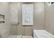 Bathroom featuring a glass-enclosed shower, a window, and a modern design at 4070 Egret Perch Ct, Ravenel, SC 29470