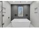 Modern bathroom featuring a sleek soaking tub with a view to the outdoors at 4070 Egret Perch Ct, Ravenel, SC 29470