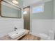 Bathroom featuring a modern floating vanity, square mirror, and large glass shower with gray tiling at 4070 Egret Perch Ct, Ravenel, SC 29470