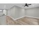 Spacious bedroom features wood-look flooring, neutral paint, and ceiling fan at 4070 Egret Perch Ct, Ravenel, SC 29470