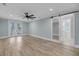 Bright bedroom with barn door, French doors to balcony and wood look floors at 4070 Egret Perch Ct, Ravenel, SC 29470