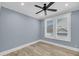 Bedroom featuring a ceiling fan, light blue walls, and a window with white frame and white trim at 4070 Egret Perch Ct, Ravenel, SC 29470