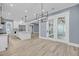Open concept dining room and kitchen area featuring new lighting and french doors at 4070 Egret Perch Ct, Ravenel, SC 29470
