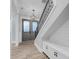 Inviting foyer featuring a striking staircase, modern lighting, and a stylish front door with decorative glass at 4070 Egret Perch Ct, Ravenel, SC 29470
