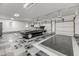 Spacious garage with epoxy flooring, multiple garage doors, and classic car parked inside at 4070 Egret Perch Ct, Ravenel, SC 29470