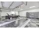 Well-organized garage featuring epoxy flooring, cabinets, multiple garage doors, and classic car at 4070 Egret Perch Ct, Ravenel, SC 29470