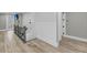 Upstairs hallway with wood-look floors, board and batten, and access to outdoor balcony at 4070 Egret Perch Ct, Ravenel, SC 29470