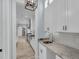 View into modern kitchen featuring stainless steel appliances and white cabinetry at 4070 Egret Perch Ct, Ravenel, SC 29470