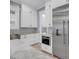 A well-lit kitchen features a stainless steel fridge, marble countertops, and white cabinets at 4070 Egret Perch Ct, Ravenel, SC 29470