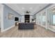 Inviting living room with fireplace, ceiling fan, and access to outdoor spaces through glass doors at 4070 Egret Perch Ct, Ravenel, SC 29470