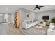 A modern living room with a white sofa, stylish decor, and a ceiling fan at 4070 Egret Perch Ct, Ravenel, SC 29470