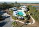Aerial view of a resort-style pool with palm trees and stylish pavilion overlooking a scenic waterway at 4070 Egret Perch Ct, Ravenel, SC 29470