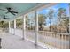 Covered porch with white railings overlooking a scenic landscape with mature trees at 4070 Egret Perch Ct, Ravenel, SC 29470
