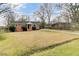 Charming single-story brick home with a long driveway and a well-manicured lawn with mature trees at 4203 Marilyn Dr, North Charleston, SC 29418