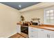 Updated kitchen featuring stainless steel appliances, white cabinets, and butcher block countertops at 4203 Marilyn Dr, North Charleston, SC 29418