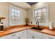 Kitchen space features white cabinets, butcher block countertop, and modern black sink at 4203 Marilyn Dr, North Charleston, SC 29418