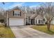 Inviting home exterior with a spacious driveway, two-car garage, and well-maintained lawn at 459 Blue Dragonfly Dr, Charleston, SC 29414