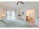 Cozy bedroom featuring a ceiling fan, plush bed, and an en-suite bathroom creating a relaxing retreat at 482 Sea Cloud Cir, Edisto Island, SC 29438