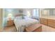 This coastal bedroom features a built-in window seat and wicker bedside tables at 482 Sea Cloud Cir, Edisto Island, SC 29438