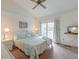 Inviting bedroom with a plush bed, tropical accents, a ceiling fan, and access to a private balcony at 482 Sea Cloud Cir, Edisto Island, SC 29438