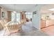 Bright dining room features a glass table, light-colored chairs, neutral carpet, and abundant natural light from the large windows at 482 Sea Cloud Cir, Edisto Island, SC 29438
