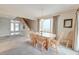 Inviting dining area with seating for six, bright light fixture, and views to the front entry and carpeted staircase at 482 Sea Cloud Cir, Edisto Island, SC 29438