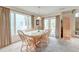 Bright dining room with a glass-top table, seating for eight, and large windows at 482 Sea Cloud Cir, Edisto Island, SC 29438
