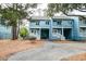 Exterior of blue two-story condos with private covered parking and white stairs at 482 Sea Cloud Cir, Edisto Island, SC 29438
