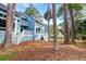 Attractive blue condos with white stairs and railings, nestled among tall trees and greenery at 482 Sea Cloud Cir, Edisto Island, SC 29438