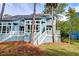 Charming two-story condo featuring light blue siding, white trim, a welcoming staircase, and multiple private balconies at 482 Sea Cloud Cir, Edisto Island, SC 29438