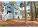 Attractive blue condos with white stairs and railings, nestled among tall trees and greenery at 482 Sea Cloud Cir, Edisto Island, SC 29438