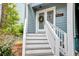 Close-up of condo entrance with wreath and storm door, stairs to the door at 482 Sea Cloud Cir, Edisto Island, SC 29438